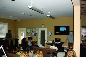 STREAMING LIVE: Sophomores view the Earth Day assembly and lister to speaker Barry Cappello while sitting comfortable in the Isham Library & Academic Research Center