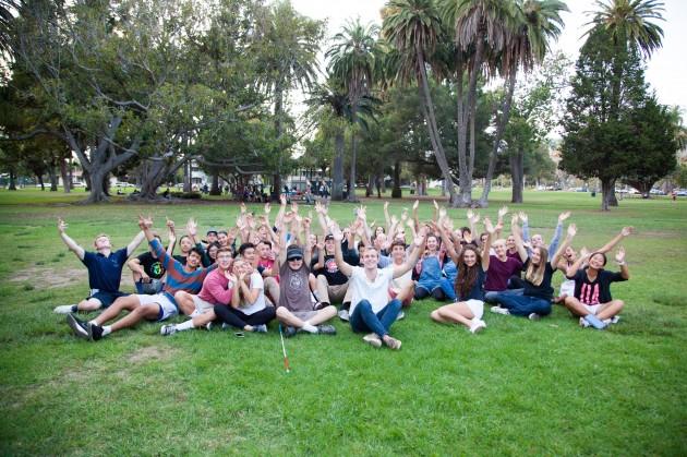 Sock Institute students put their hands in the air before handing out socks to street friends.  